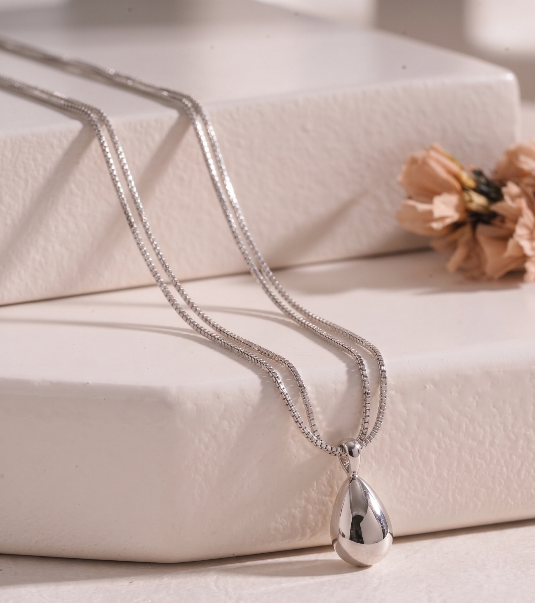 Silver-tone teardrop double-strand necklace by Prifine featuring smooth, polished teardrop-shaped pendants on layered chains.