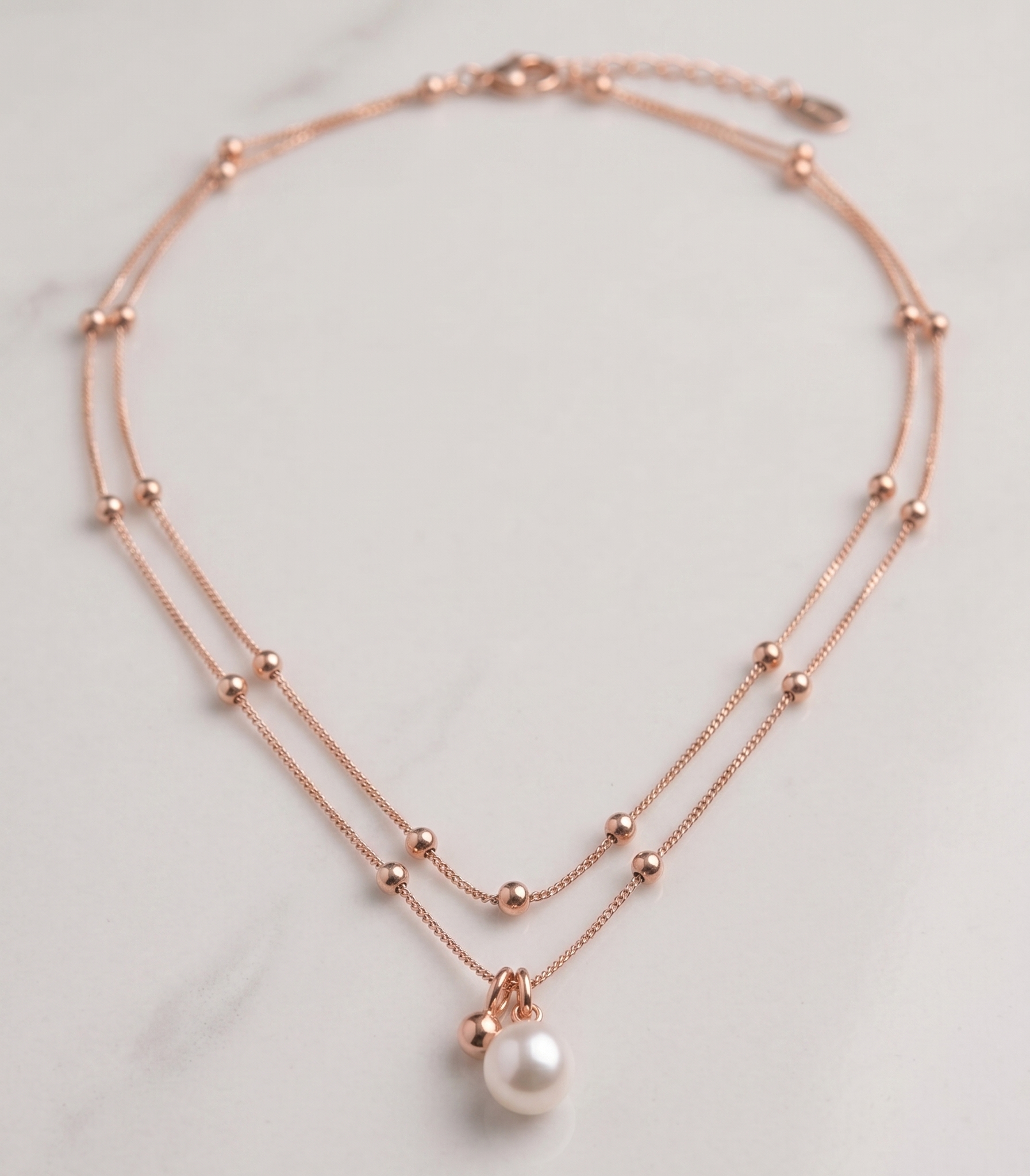 Rose gold double-strand pearl and bead necklace by Prifine featuring elegant pearls and beads on a delicate chain.