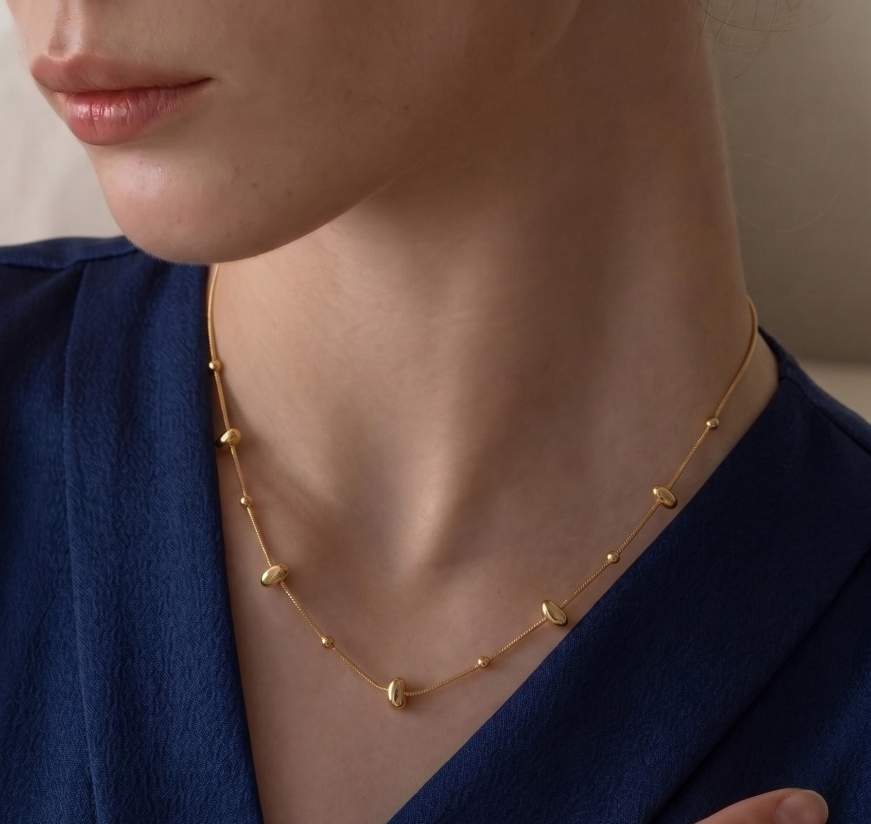 Prifine minimalist gold pebble bead chain necklace featuring small, smooth gold beads on a delicate chain.
