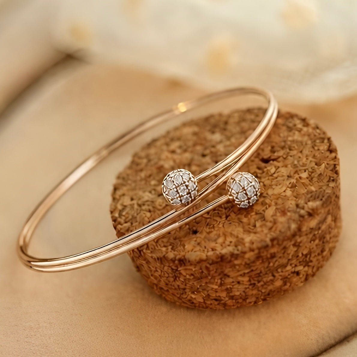 Prifine twin sphere open bangle in 18K gold plating, showcasing a sleek, modern jewelry design with two spherical accents.
