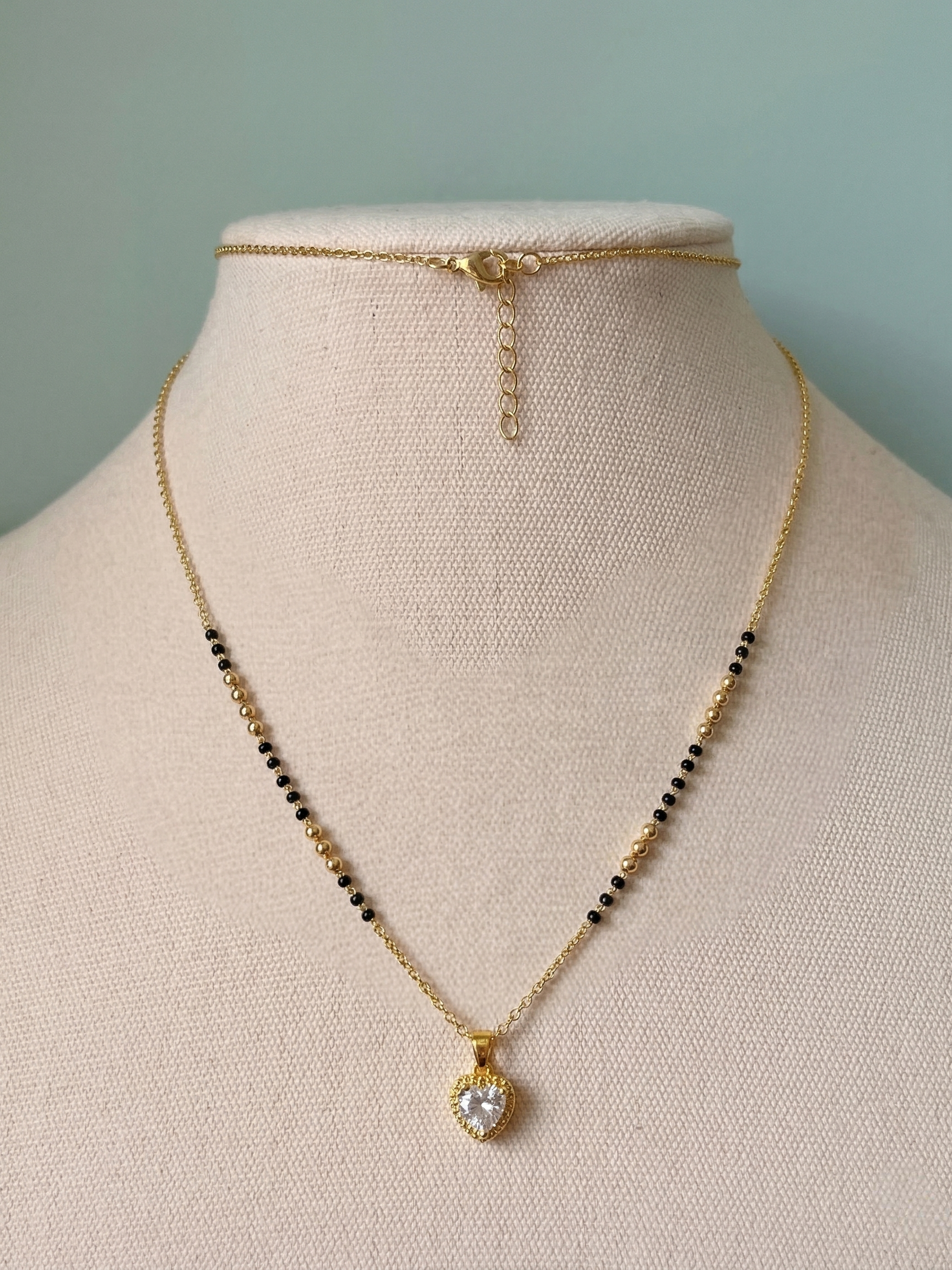 Prifine Luxe Senorita Mangalsutra featuring intricate gold design with black beads and traditional pendant.