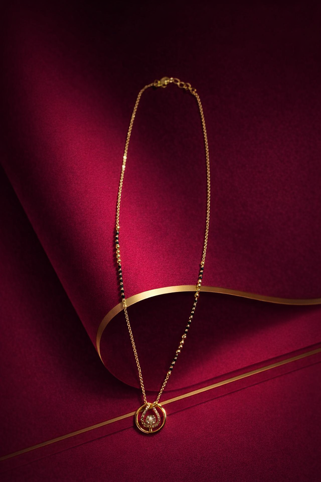 Golden Dew Mangalsutra by Prifine featuring a traditional black-bead chain with a delicate gold pendant design.