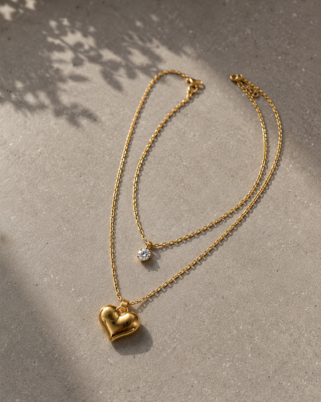 Gold tone layered heart pendant necklace by Prifine, featuring multiple heart charms on a delicate chain.