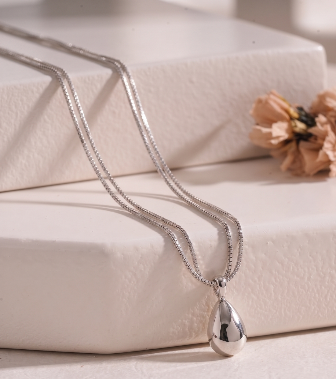 Silver-tone teardrop double-strand necklace by Prifine featuring smooth, polished teardrop-shaped pendants on layered chains.