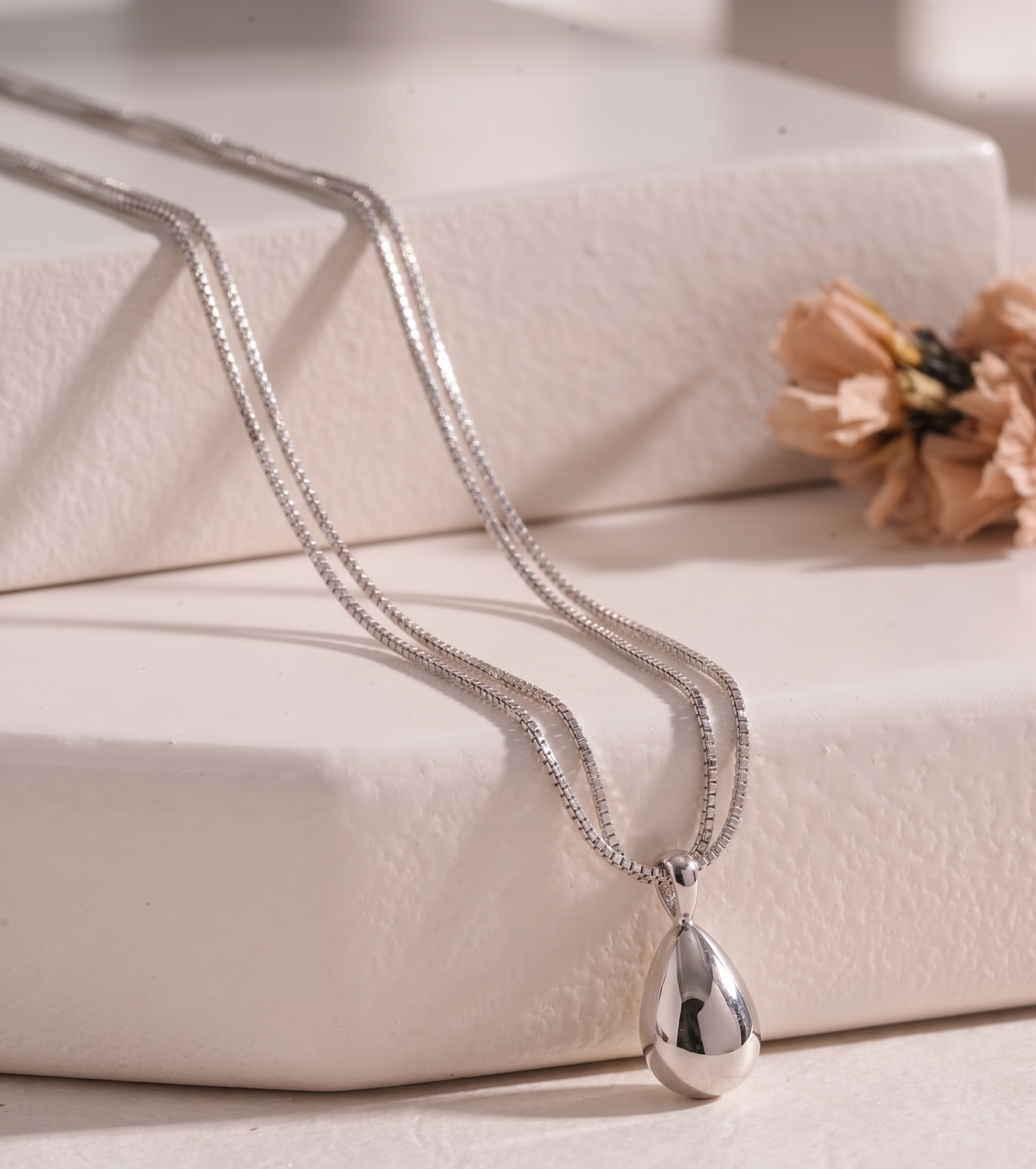 Silver-tone teardrop double-strand necklace by Prifine featuring smooth, polished teardrop-shaped pendants on layered chains.
