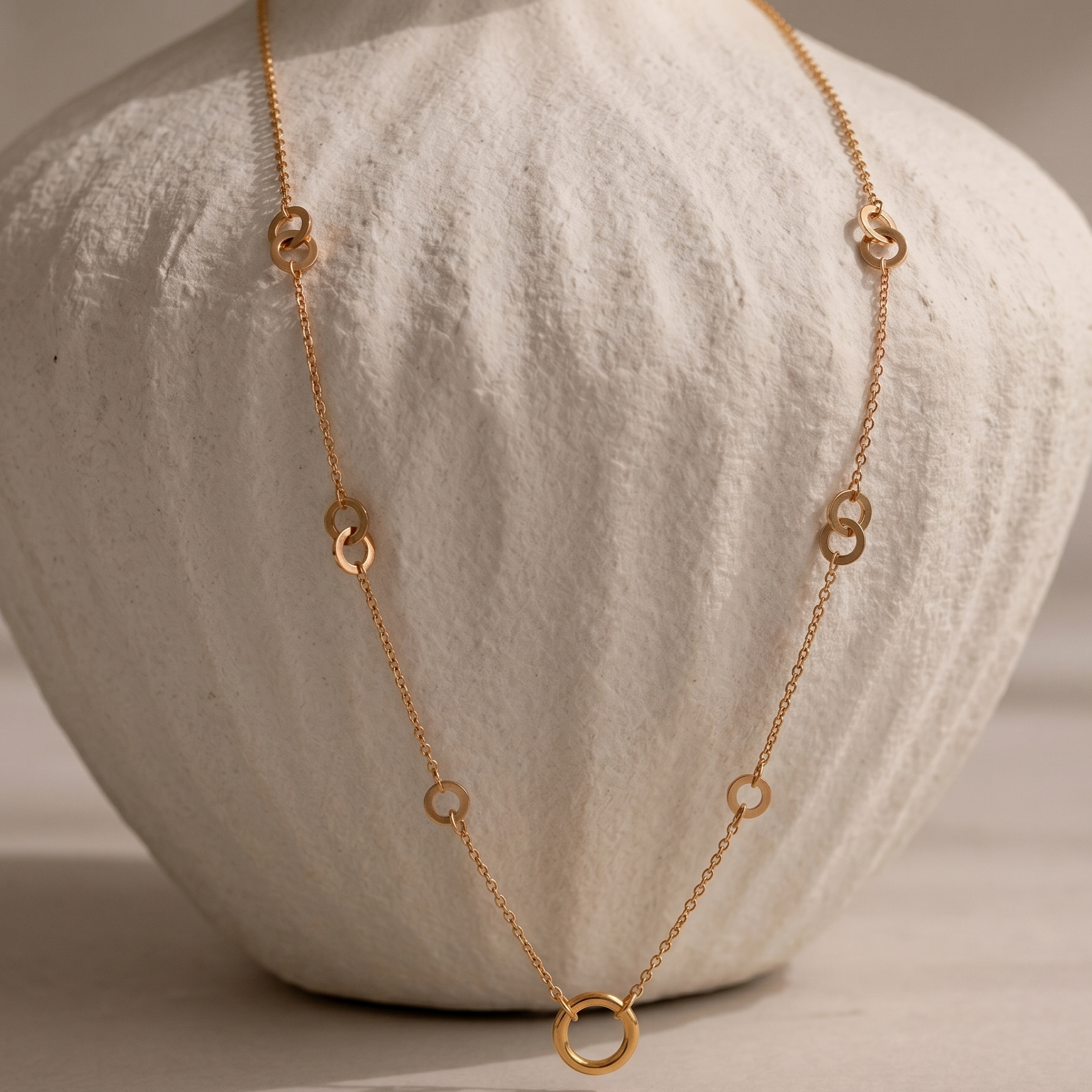 Prifine minimal gold necklace with a circular charm, featuring sleek and trendy jewelry design on a white background.