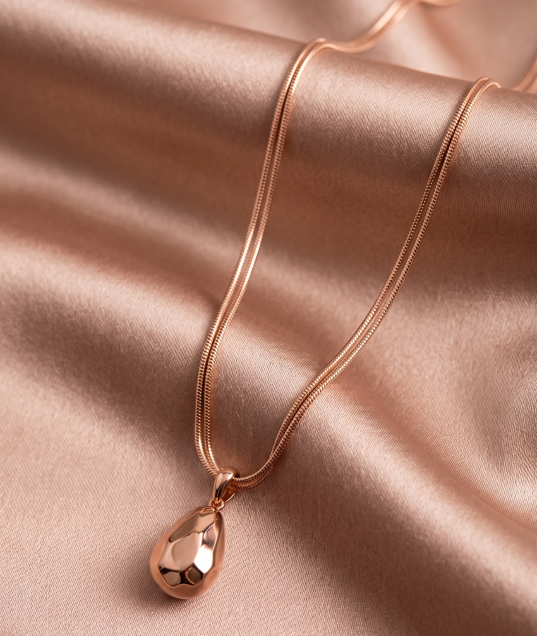 Rose gold hammered teardrop pendant necklace by Prifine, featuring a textured, elegant teardrop-shaped charm on a fine chain.