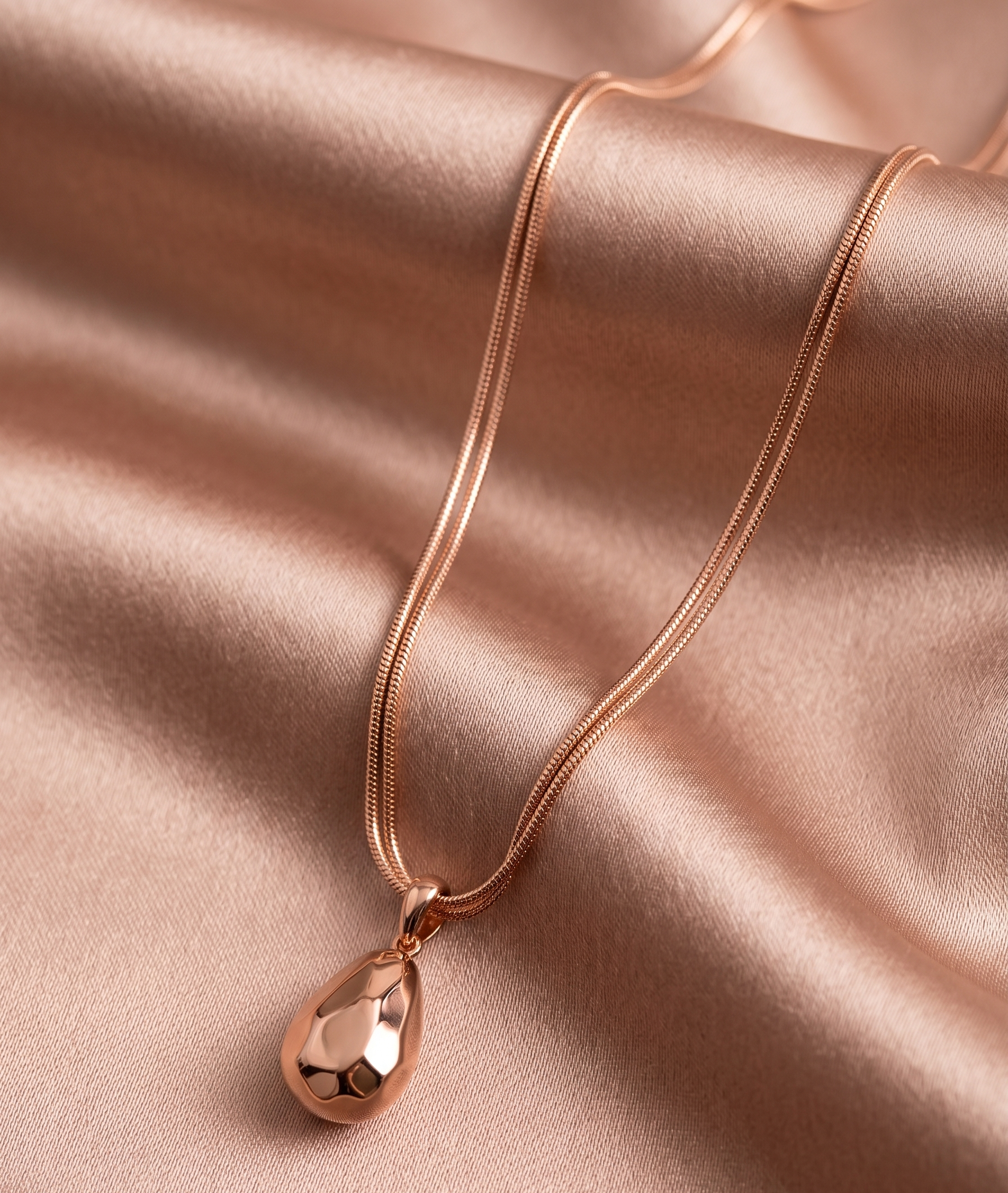 Rose gold hammered teardrop pendant necklace by Prifine, featuring a textured, elegant teardrop-shaped charm on a fine chain.