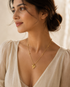 Gold heart pendant necklace with beaded chain, 18K gold plated, elegant jewelry by Prifine, shown on a neutral background.