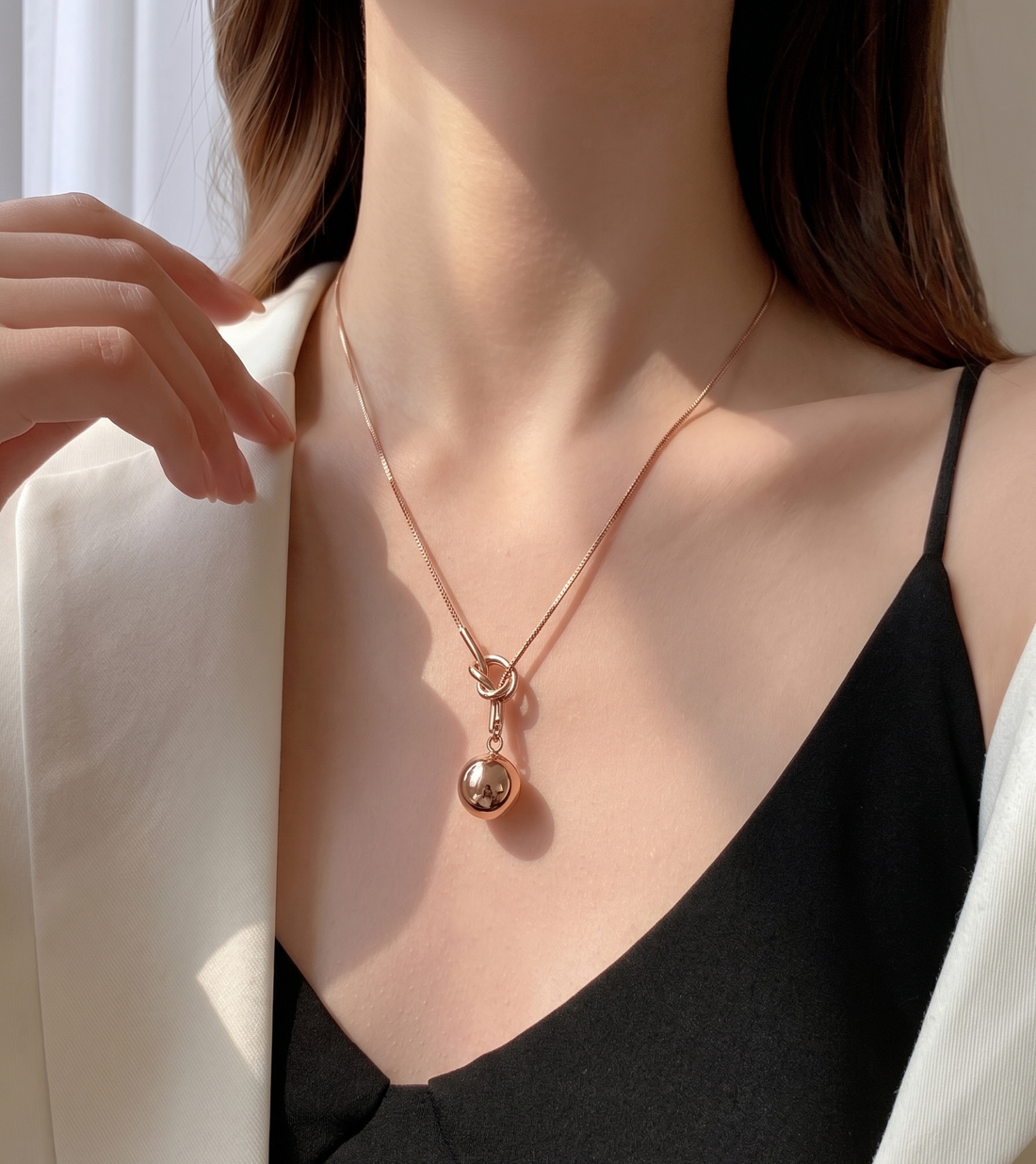 Rose gold knot and sphere pendant necklace by Prifine featuring a delicate chain and elegant jewelry design.