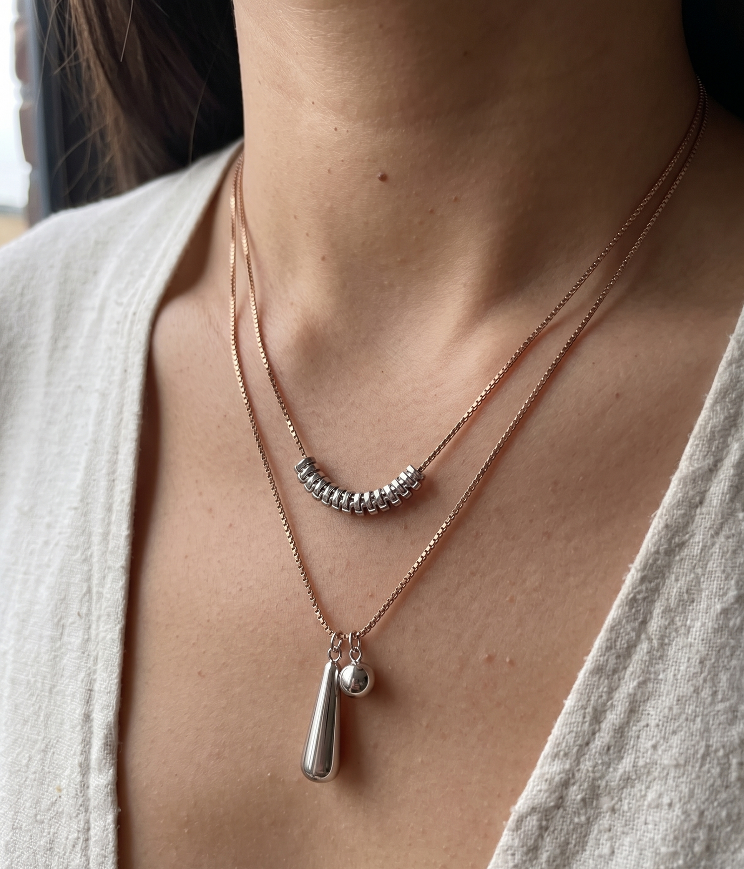 Rose gold Venetian chain by Prifine with silver-tone geometric pendants, showcasing intricate links and modern jewelry design.