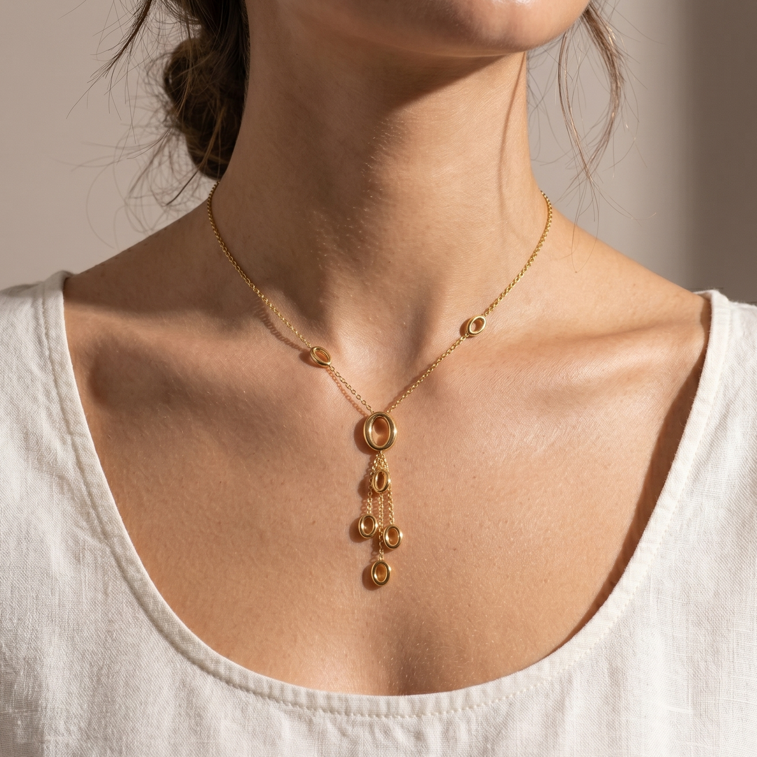 Prifine gold drop pendant necklace featuring dangling circle charms on a delicate chain.