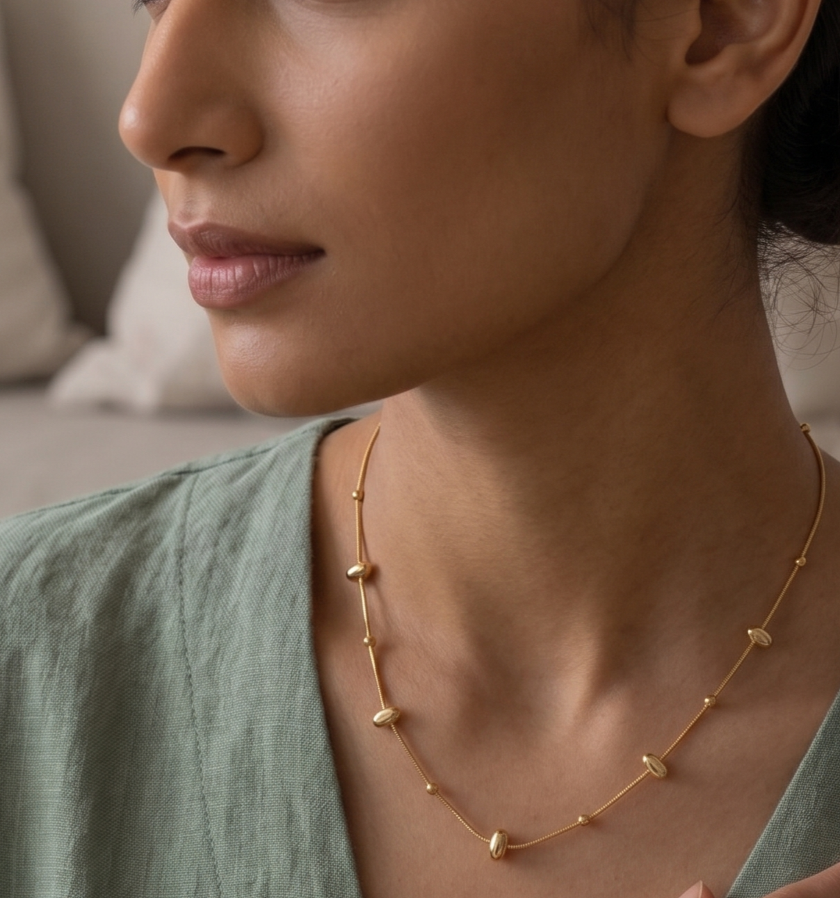 Minimalist gold pebble bead chain necklace by Prifine, featuring small smooth oval-shaped beads on a delicate chain.