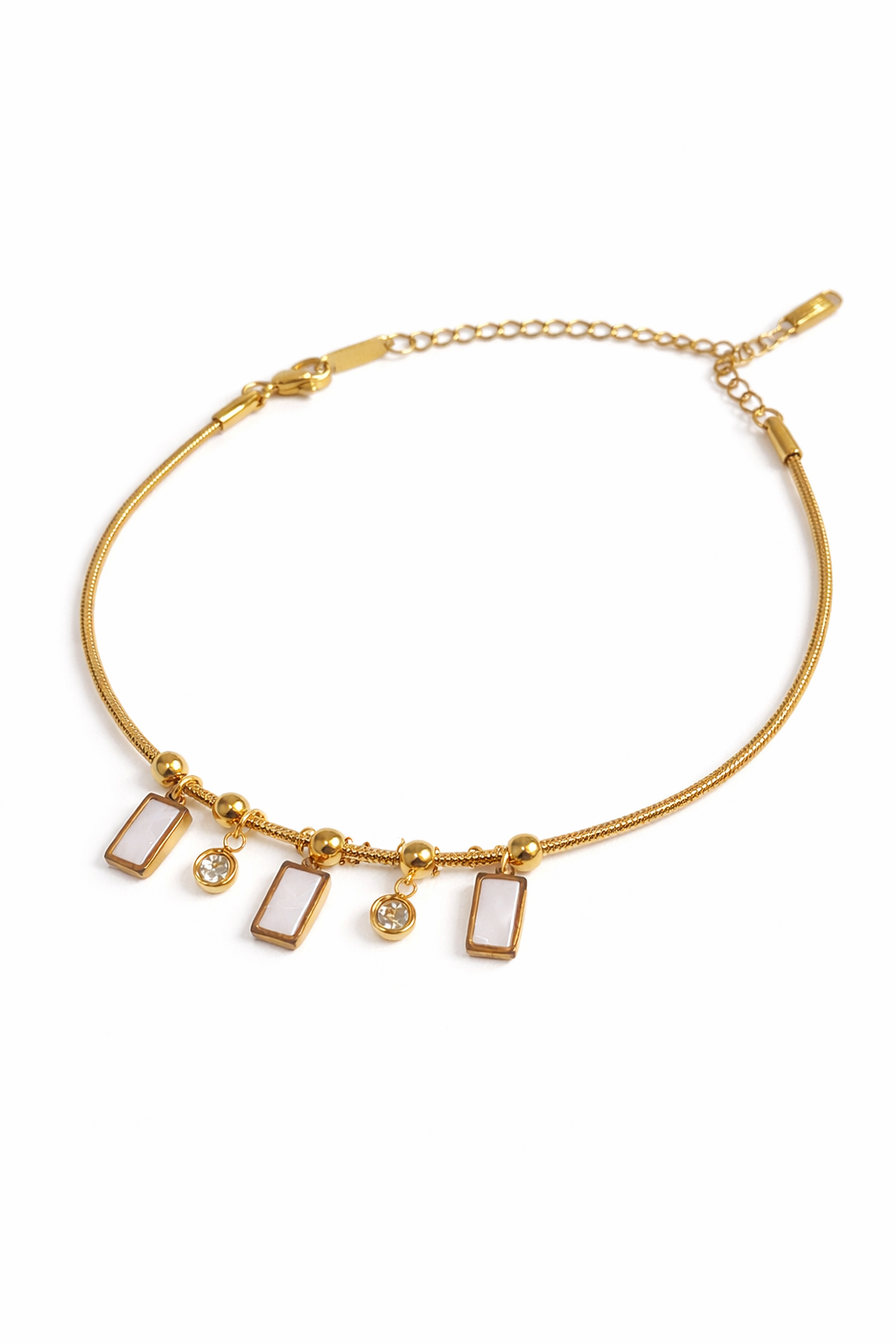 Gold plated charm bracelet by Prifine featuring various decorative charms and a secure clasp on a plain background.