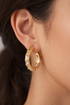Prifine gold stone studded hoop earrings with embedded gemstones, showcasing a stylish and elegant jewelry design.