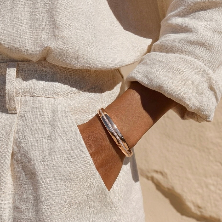 Prifine Twisted Ribbon Pave Bracelet in 18K gold-plated sculptural cuff design on a white background.