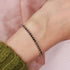 18k gold-plated black spinel tennis bracelet by Prifine featuring sparkling black spinel stones on a delicate gold chain.