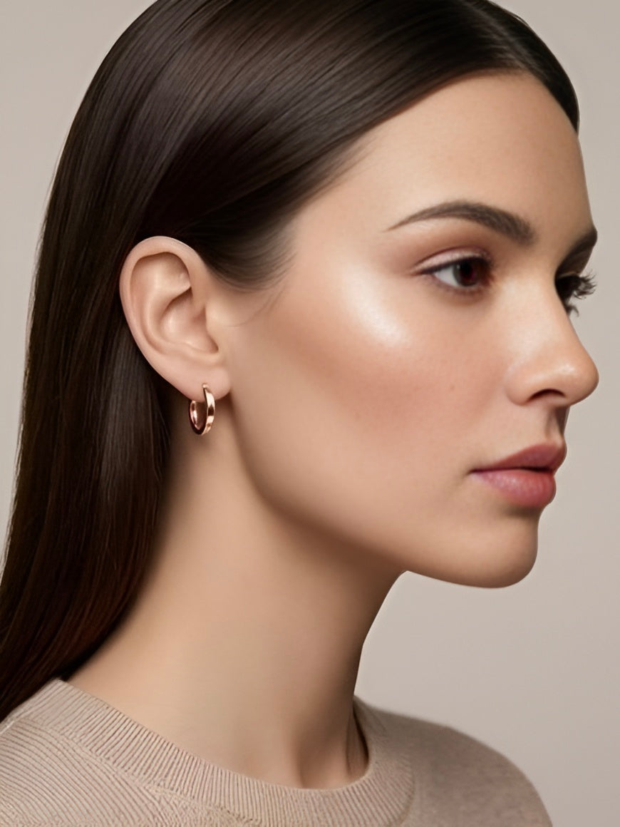 Prifine classic rose gold hoop earrings with smooth, polished finish, hanging from pierced ears in a close-up shot.