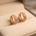 Prifine Aura princess-cut double row rose gold huggie earrings with sparkling gemstones, close-up view of elegant jewelry.