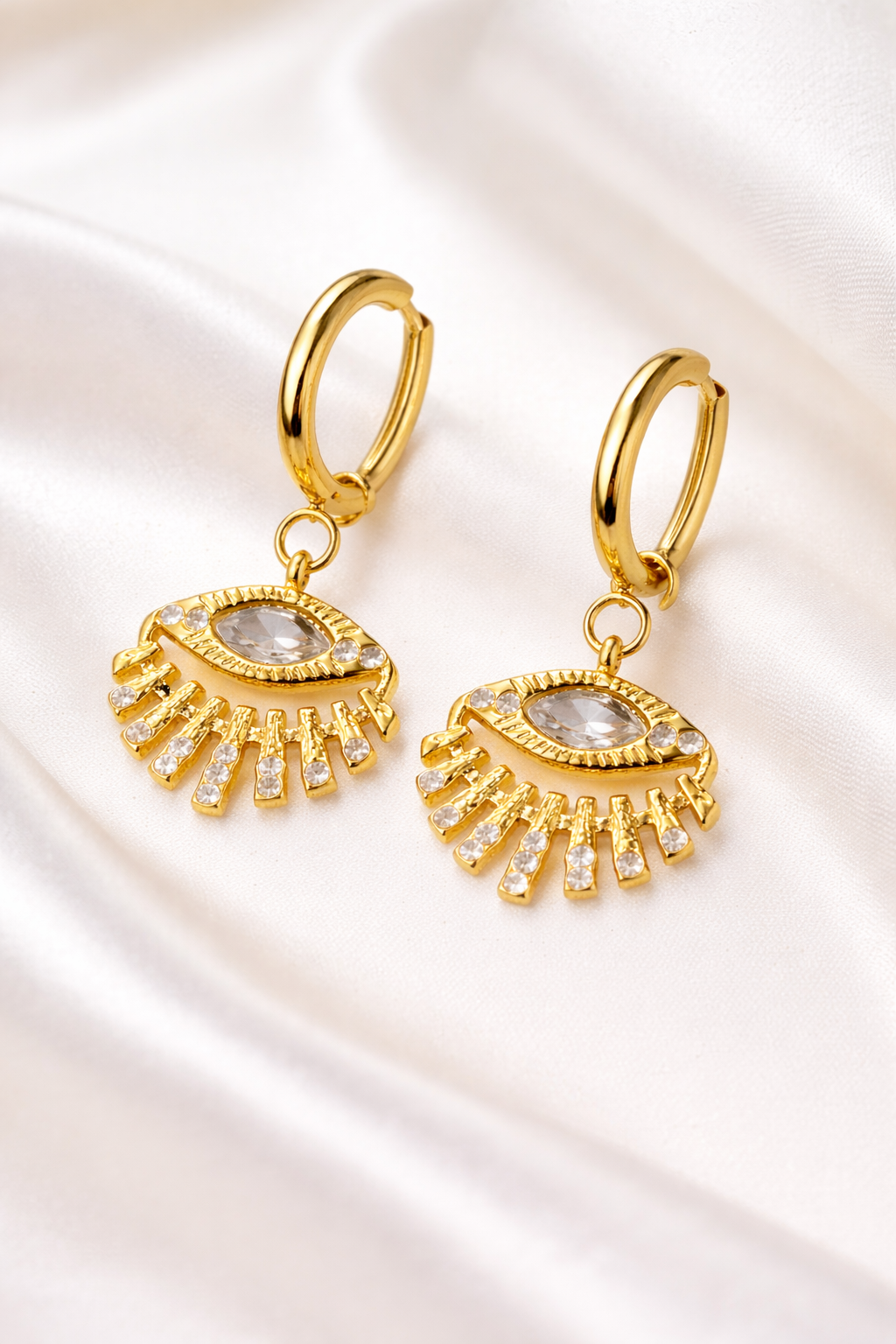 Gold plated stylish evil eye earring by Prifine featuring a vibrant blue and white evil eye design on a gold hoop.
