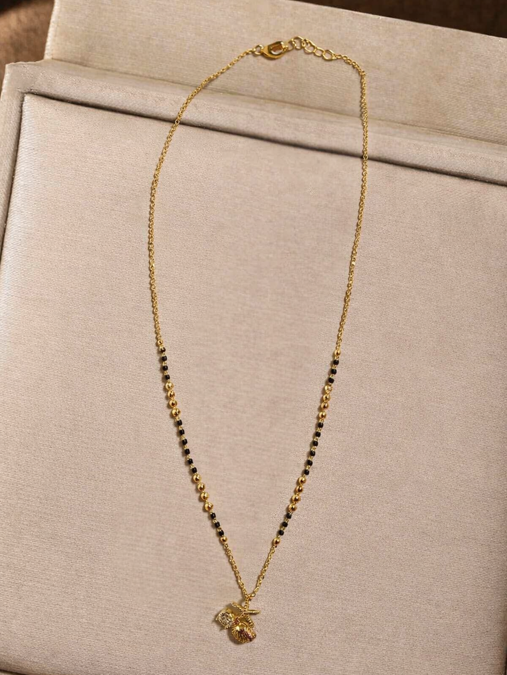 Golden Aura Mangalsutra by Prifine featuring a delicate chain with intricate pendant design.