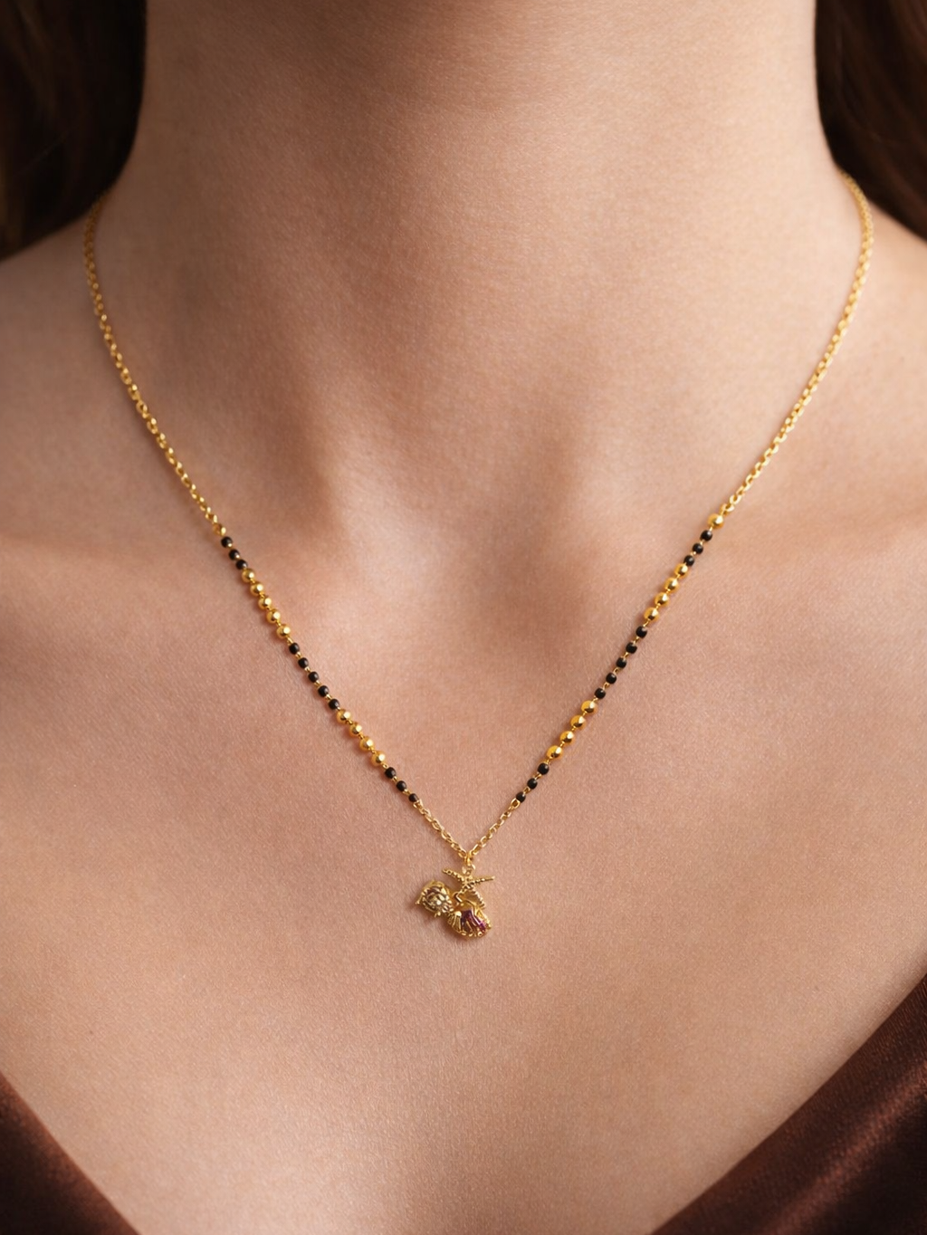 Golden Aura Mangalsutra by Prifine featuring a delicate chain with intricate pendant design for traditional Indian jewelry.