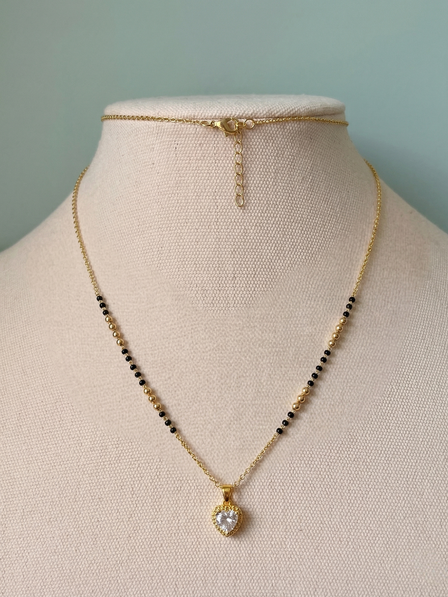 Prifine Luxe Senorita Mangalsutra featuring intricate gold design with black beads and traditional pendant.