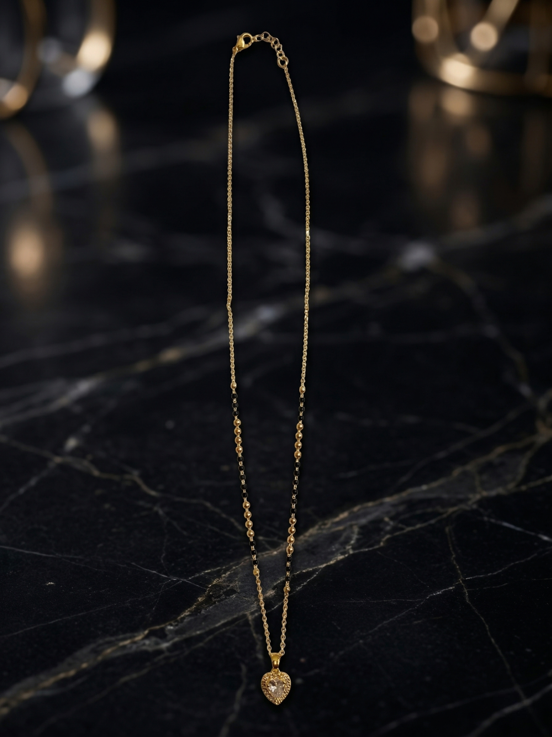Elegant Luxe Senorita Mangalsutra by Prifine featuring gold chain with intricate pendant design.