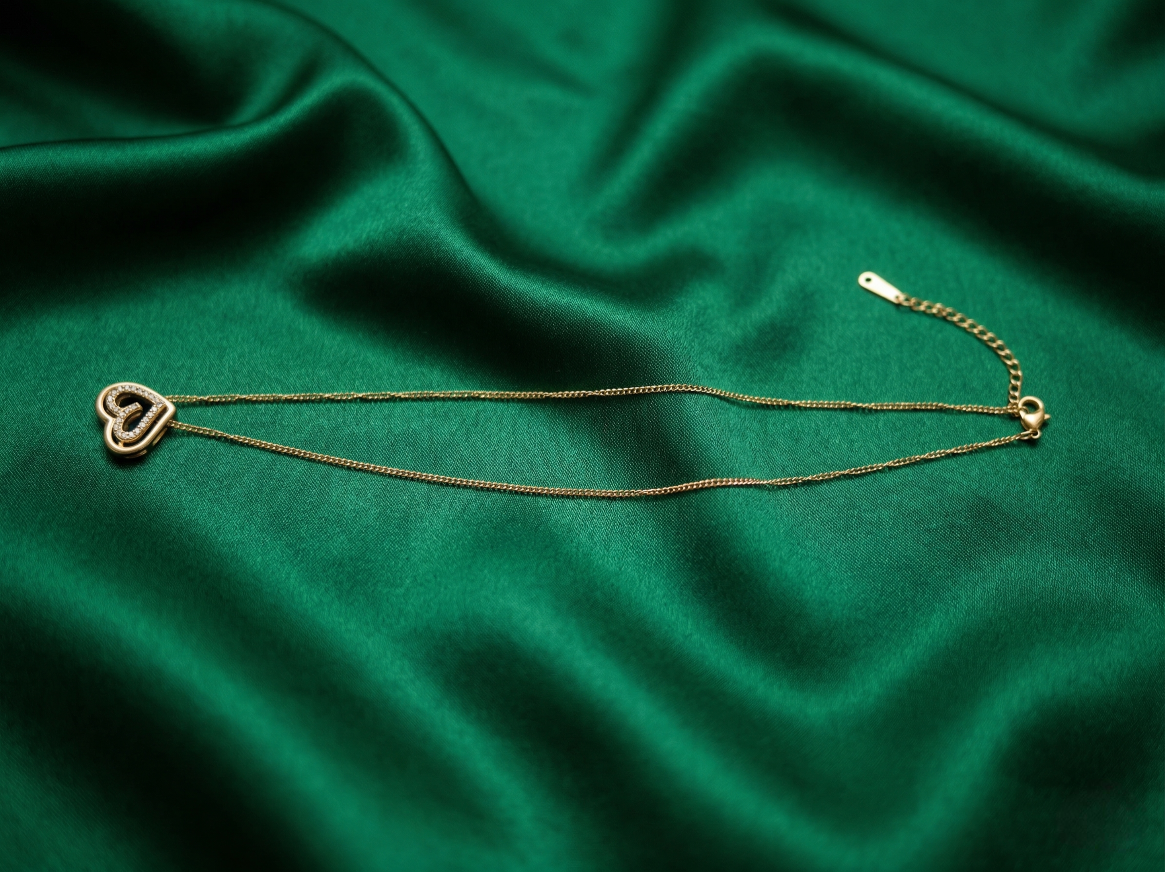Golden Heart Duo Pendant Necklace by Prifine showing two intertwined heart charms on a silver chain.