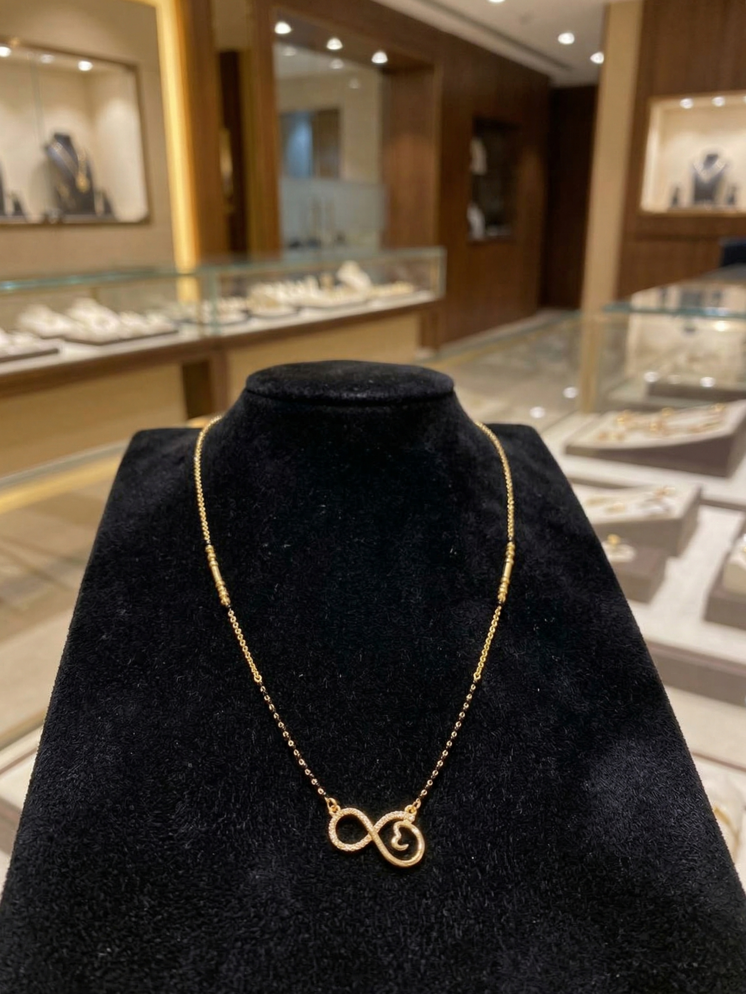 Prifine Infinity Mangalsutra featuring a gold chain with infinity pendant and traditional Indian jewelry design.