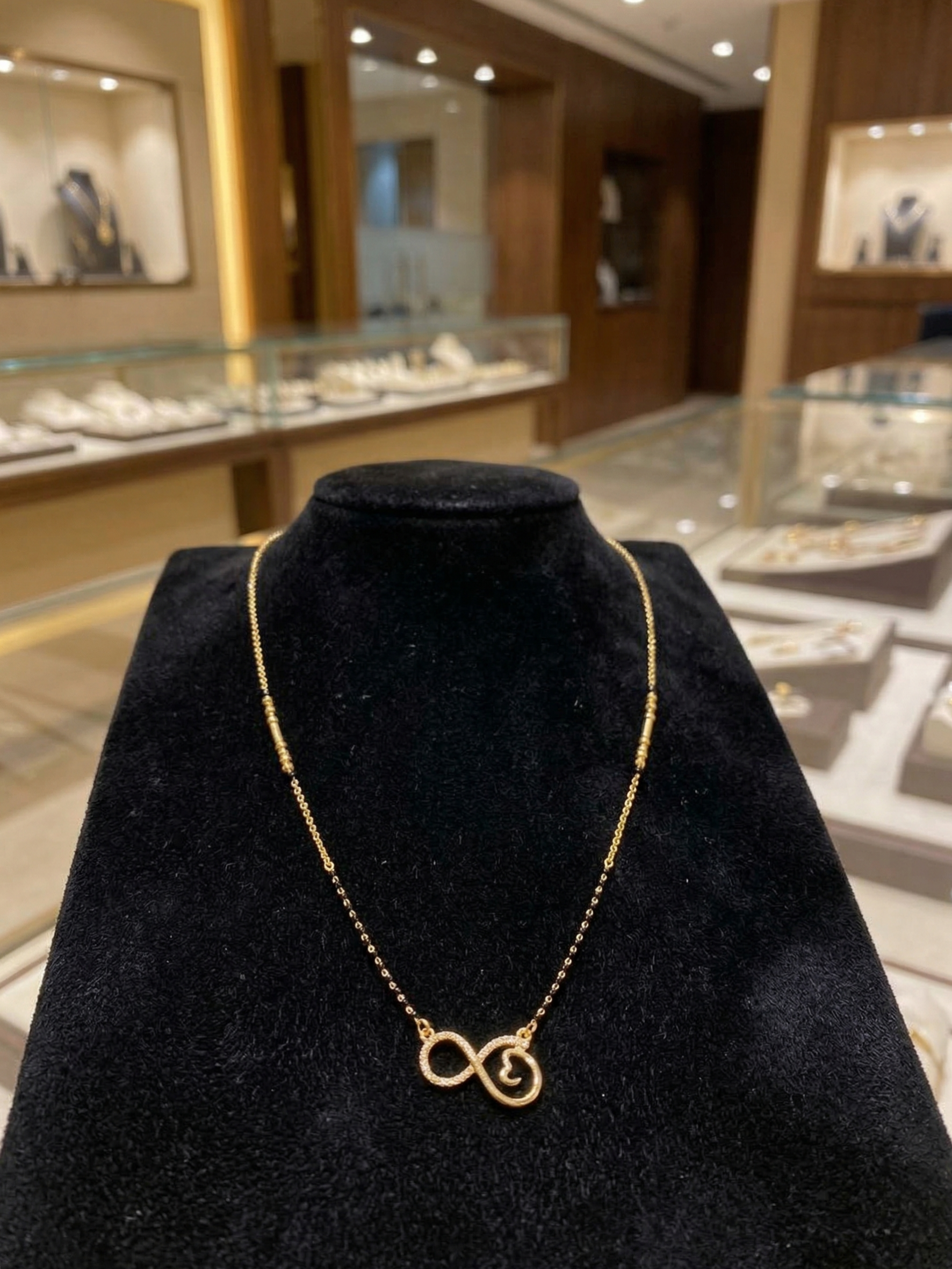 Prifine Infinity Mangalsutra featuring a gold chain with infinity pendant and traditional Indian jewelry design.