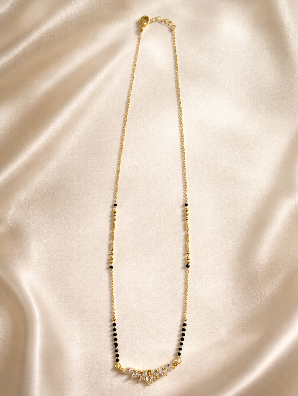 Prifine Saruchi Mangalsutra featuring traditional gold chain and pendant, laid out on a plain background.