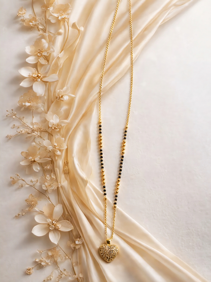 Gold heart charm mangalsutra with intricate design from Prifine, featuring a delicate chain and elegant pendant.