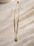Golden heart charm mangalsutra with black beads and gold chain, traditional Indian jewelry by Prifine.
