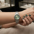 Prifine elegant silver watch with a green dial, showcasing a sleek design and silver strap on a white background.