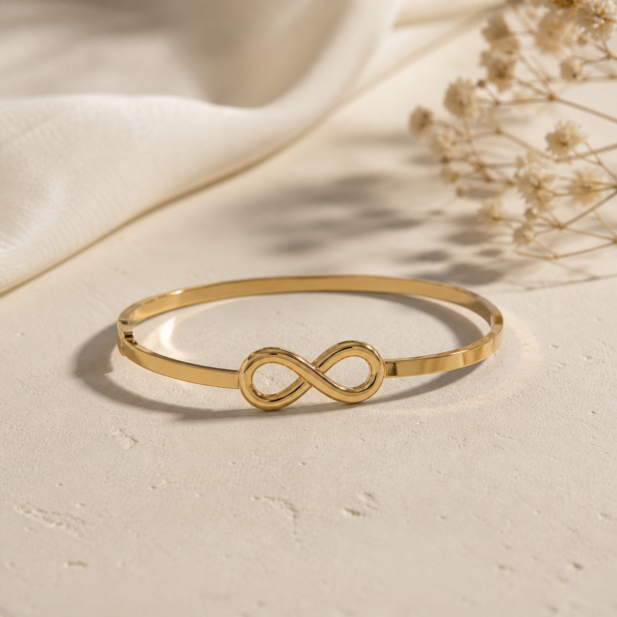Gold-plated Infinity Elegance bracelet by Prifine featuring a sleek, stylish design on a white background.